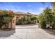 Gated estate entrance with lush landscaping and driveway at 66 Biltmore Est, Phoenix, AZ 85016