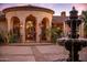 Stunning home exterior with fountain and arched entryway at 66 Biltmore Est, Phoenix, AZ 85016