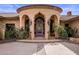 Exterior view of a grand home with a unique entryway at 66 Biltmore Est, Phoenix, AZ 85016