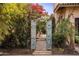 Ornate arched gate entrance to a private garden oasis at 66 Biltmore Est, Phoenix, AZ 85016