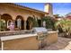 Built-in outdoor kitchen with stainless steel appliances at 66 Biltmore Est, Phoenix, AZ 85016