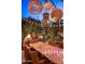 Romantic outdoor dining area with unique lighting and lush greenery at 66 Biltmore Est, Phoenix, AZ 85016