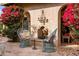 Peaceful patio with fireplace, seating, and bougainvillea plants at 66 Biltmore Est, Phoenix, AZ 85016