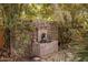 Serene stone water feature surrounded by lush greenery at 66 Biltmore Est, Phoenix, AZ 85016