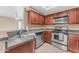 Kitchen with wood cabinets and stainless steel appliances at 750 E Northern Ave # 1134, Phoenix, AZ 85020