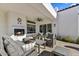 Relaxing patio with seating area, fireplace, and ceiling fan at 8027 E Juan Tabo Rd, Scottsdale, AZ 85255