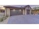 Two-car garage with upgraded doors and landscaping at 8760 E Hackamore Dr, Scottsdale, AZ 85255