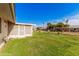 Spacious backyard with grassy area and shed at 9245 N 109Th Dr, Sun City, AZ 85351