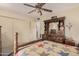 Bedroom with a wooden bed frame, dresser and access to another room at 9245 N 109Th Dr, Sun City, AZ 85351
