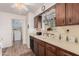 Clean kitchen with wood cabinets, double sink, and access to laundry room at 9245 N 109Th Dr, Sun City, AZ 85351