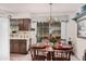 Bright kitchen with a dining area, wood cabinets, and a view to the backyard at 9245 N 109Th Dr, Sun City, AZ 85351