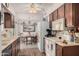 Well-equipped kitchen with ample cabinetry and a view of the dining area at 9245 N 109Th Dr, Sun City, AZ 85351