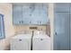 Laundry room with washer, dryer, and ample overhead storage at 9245 N 109Th Dr, Sun City, AZ 85351