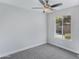 Bright bedroom with neutral walls and carpet, featuring a window with backyard view at 1055 N Recker Rd # 1215, Mesa, AZ 85205