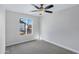 Second bedroom with window, ceiling fan, and gray carpeting at 1055 N Recker Rd # 1215, Mesa, AZ 85205