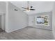 Spacious living room with grey vinyl plank flooring, a ceiling fan, and large window at 1055 N Recker Rd # 1215, Mesa, AZ 85205