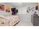 Bedroom with large bed, dresser, and guitar at 1075 E Chandler Blvd # 120, Chandler, AZ 85225