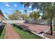 Artificial turf backyard with red tile patio and basketball court at 11209 N 40Th St, Phoenix, AZ 85028