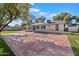 Large backyard with expansive concrete patio, artificial turf, and mature shade tree at 11209 N 40Th St, Phoenix, AZ 85028