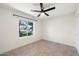 Well-lit bedroom with ceiling fan and large window at 11209 N 40Th St, Phoenix, AZ 85028