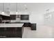 Modern kitchen with dark cabinetry and quartz countertops at 11243 E Flintlock Dr, Chandler, AZ 85249