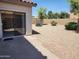 Spacious backyard with gravel ground cover and a sliding glass door at 11432 E Quicksilver Ave, Mesa, AZ 85212