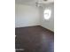 Spacious bedroom with wood-look tile floor and ceiling fan at 11432 E Quicksilver Ave, Mesa, AZ 85212