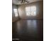 Spacious bedroom with hardwood floors and large window at 11432 E Quicksilver Ave, Mesa, AZ 85212