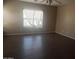 Spacious bedroom with hardwood floors and large window at 11432 E Quicksilver Ave, Mesa, AZ 85212