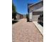 Gravel driveway next to the house and garage with a truck parked at 11432 E Quicksilver Ave, Mesa, AZ 85212