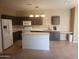 Kitchen with island, dark cabinets, and tile floors at 11432 E Quicksilver Ave, Mesa, AZ 85212