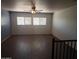 Bright living room with wood-look tile floor and ceiling fan at 11432 E Quicksilver Ave, Mesa, AZ 85212