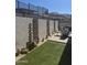 This backyard is complete with artificial turf, desert landscaping, and a dining area at 12411 E Troon Vista Dr, Scottsdale, AZ 85255