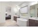 Elegant bathroom with a free-standing tub, double vanity, and view into bedroom at 12411 E Troon Vista Dr, Scottsdale, AZ 85255