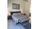 This primary bedroom features a neutral color palette, modern art, and an ensuite bathroom at 12411 E Troon Vista Dr, Scottsdale, AZ 85255