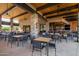 Covered patio with tables and chairs in community center at 12411 E Troon Vista Dr, Scottsdale, AZ 85255