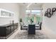 Modern dining room with glass table and six black chairs at 12411 E Troon Vista Dr, Scottsdale, AZ 85255