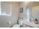 Clean and modern half bathroom with white vanity and toilet at 1253 E Debbie Dr, San Tan Valley, AZ 85140