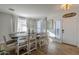 Bright dining room with a rustic farmhouse table and six chairs at 1253 E Debbie Dr, San Tan Valley, AZ 85140