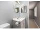 Bathroom with white vanity, round mirror, and tile floor at 13428 N 36Th Pl, Phoenix, AZ 85032