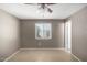 Bright bedroom with ceiling fan and tile floors at 13428 N 36Th Pl, Phoenix, AZ 85032