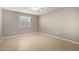 Well-lit bedroom with tile floors and window blinds at 13428 N 36Th Pl, Phoenix, AZ 85032