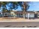 Single story home with gray exterior, landscaping, and a two-car garage at 13428 N 36Th Pl, Phoenix, AZ 85032