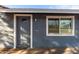 Gray front door with a window and white trim at 13428 N 36Th Pl, Phoenix, AZ 85032