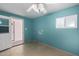 Laundry room with white cabinets, a door to outside, and tile flooring at 13428 N 36Th Pl, Phoenix, AZ 85032