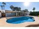 Kidney shaped pool with a covered patio area at 13428 N 36Th Pl, Phoenix, AZ 85032