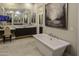 Luxurious bathroom with soaking tub, double vanity, and large mirror at 13767 N Prospect Trl, Fountain Hills, AZ 85268