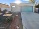 House exterior with a teal garage door and desert landscaping at 1433 E Kerry Ln, Phoenix, AZ 85024