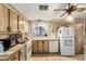 Galley kitchen with wood cabinets and appliances at 1471 E 22Nd Ave, Apache Junction, AZ 85119