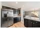 Sleek kitchen with dark cabinetry, stainless steel refrigerator, and white countertops at 15550 N Frank Looyd Wright Blvd # 1057, Scottsdale, AZ 85260